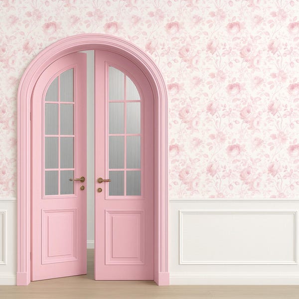 May include: A pink arched double door with glass panels and brass hardware. The door is set against a floral wallpaper with a white wainscoting and a light wood floor. The overall aesthetic is romantic and vintage.