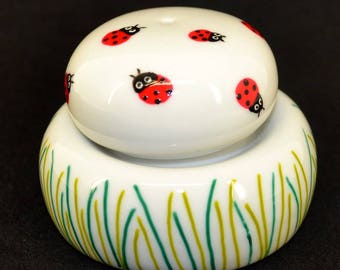 Salt and pepper porcelain Pebble shape. Ladybug in the Meadow scene.