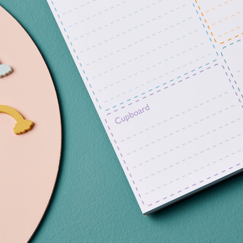 May include: A white checklist with a section labeled "Cupboard" with lines for writing. The checklist has a blue, purple, and orange dashed border.