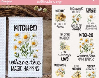 May include: White kitchen towels with daisy floral designs and the text "KITCHEN" and "where the MAGIC HAPPENS". The image also shows other designs with text like "blessed are those", "meals and memories", and "the heart of the home".