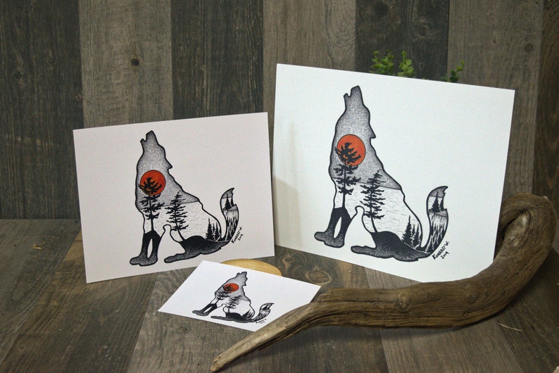 May include: Three different sizes of prints featuring a black and white silhouette of a wolf howling at the moon. The wolf's silhouette is filled with a forest scene, including trees and a red sun. The prints are on white paper and have a black border.