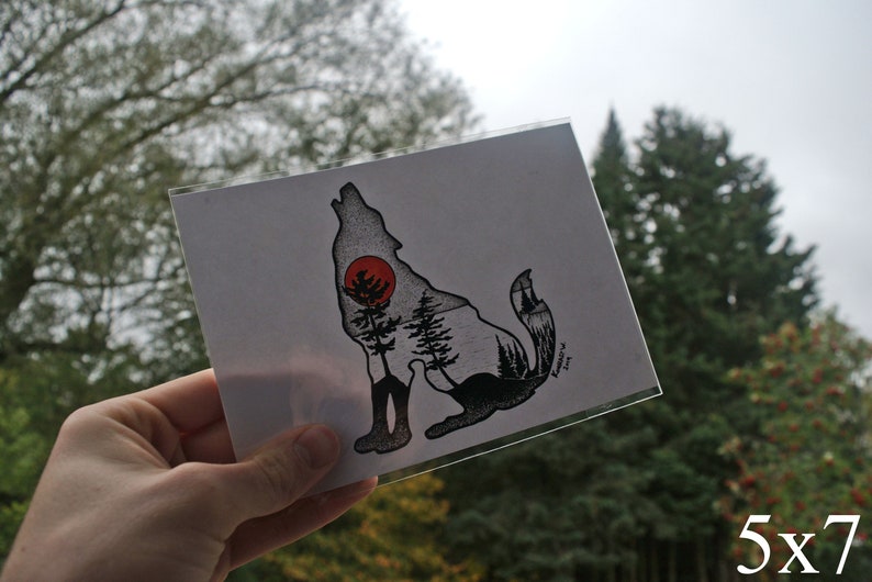 May include: A black and white illustration of a wolf howling at the moon. The wolf is silhouetted against a forest scene with a red sun in the background. The print is 5x7 inches.
