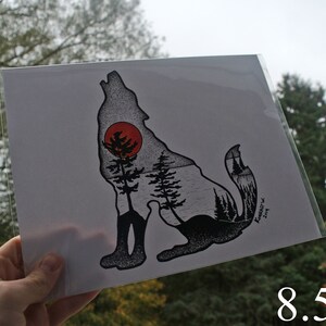 May include: Black and white illustration of a wolf howling at the moon. The wolf is silhouetted against a red moon and a forest scene. The image is printed on white paper and measures 8.5 x 11 inches.