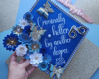 Criminally hotter by another degree/ Graduation Cap Toppers/ Flower graduation cap/ Glitter/ Customizable/ blue and gold/ criminal justice