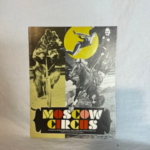 May include: A vintage program for the Moscow Circus, featuring a black bear riding a bicycle, a woman performing an aerial act, and a man riding a horse. The program is printed on yellow paper with black and red text. The text reads "Moscow Circus" and "Seventy-Five Cents".
