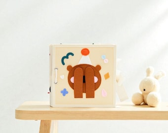 Handmade Montessori busy book - a sensory travel toy for toddlers.