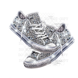 May include: A pair of silver glitter trainers with white laces. The trainers are in a casual style and have a classic design.