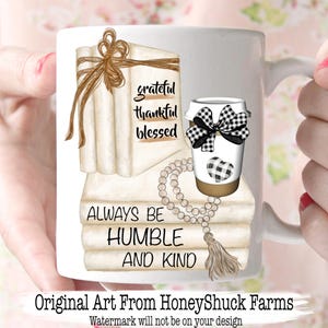 May include: A white ceramic mug featuring a graphic of stacked books tied with twine, a coffee cup with a black and white buffalo check bow and heart, and a beaded tassel. The text reads grateful thankful blessed and ALWAYS BE HUMBLE AND KIND.