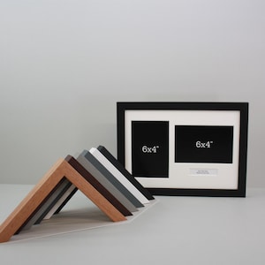 May include: A black double picture frame with two 15x10 cm openings, and a selection of wooden frame corner samples in various colours. The samples include light wood, brown, grey, and white.