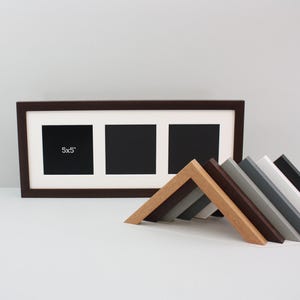 May include: A dark brown triple photo frame with three 12.7x12.7 cm openings. A selection of angled frame samples in various colors, including wood grain, brown, grey, and black, are arranged in front of the frame.