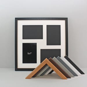 May include: A black multi-aperture picture frame with a white mount, displaying four openings. A smaller opening is labelled "5x7". Several angled frame samples in various colours are in front of the frame.