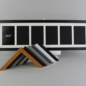 May include: A black panoramic picture frame with a white mount featuring six rectangular apertures for 6x4 inch photos. In front, a collection of angled frame corner samples in various finishes including light wood, dark wood, grey, and white.