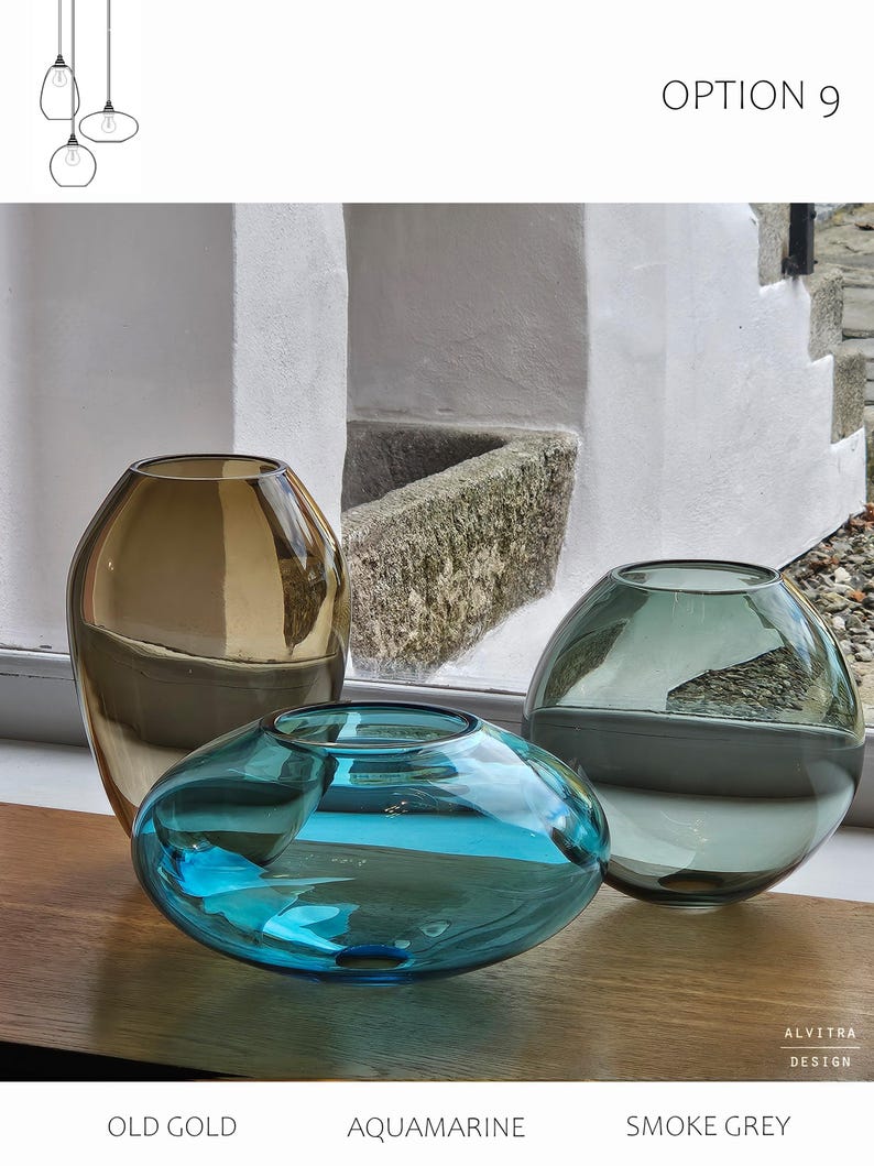 May include: Three glass vases in old gold, aquamarine, and smoke grey. The vases are different shapes: one tall and rounded, one low and oval, and one spherical. The text "OPTION 9" is visible at the top.