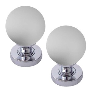 May include: Two chrome door knobs with frosted glass spheres. The knobs are round and have a smooth, polished finish.