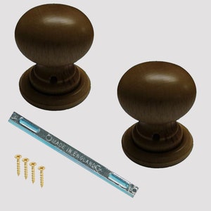 May include: Two brown wooden door knobs with a silver metal plate and screws. The plate has the text "Made in England" on it.