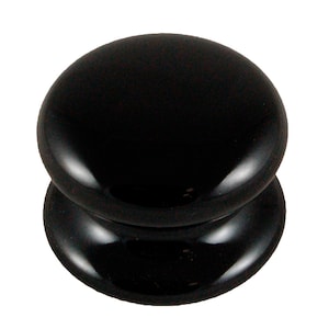 May include: A shiny black cabinet knob, featuring a rounded top and a broader base. The knob has a smooth, reflective surface, suitable for use on drawers or cabinet doors.
