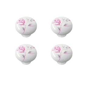 May include: Four white ceramic cabinet knobs with a pink rose floral design.
