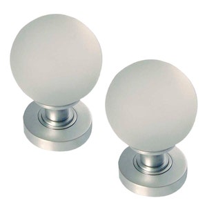 May include: Two frosted glass door knobs with a silver base. The knobs are round and have a smooth, frosted finish.