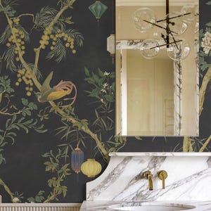May include: A bathroom with a dark floral wallpaper featuring a bird, branches, and lanterns. A marble countertop with a sink and gold fixtures is below a large mirror. A modern light fixture hangs from the ceiling.