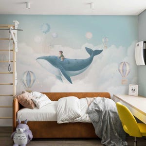 May include: A blue whale with a child sitting on its back flies through the clouds with hot air balloons. The whale is flying over a white cloud with a light blue background.