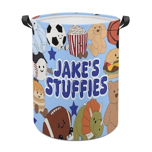 May include: A light blue storage bin with black handles, featuring cartoon illustrations of a soccer ball, popcorn, a dog, a basketball, and more. The text "JAKE'S STUFFIES" is displayed in blue bubble letters.