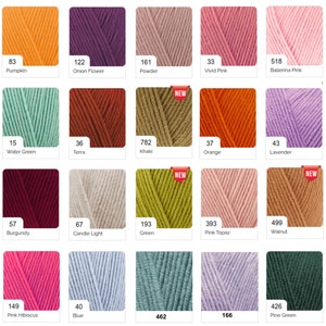 May include: A grid of yarn skeins in various colors, including orange, purple, pink, green, and blue. Each skein is labeled with a color name and number. Some skeins have a "NEW" sticker. Ideal for knitting and crochet projects.