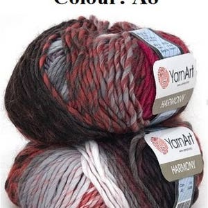 May include: Two skeins of YarnArt Harmony yarn in colour A8. The yarn is a blend of dark brown, red, grey, and white. Each skein has a label with the YarnArt logo and the word "HARMONY".
