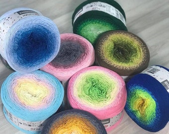 May include: A collection of colorful yarn skeins in various shades of blue, pink, green, and yellow. The yarn is arranged in a circular pattern, with each skein displaying a gradient of colors. The image showcases the texture and vibrant hues of the yarn.