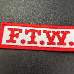 May include: Red and white embroidered patch with the text "F.T.W."