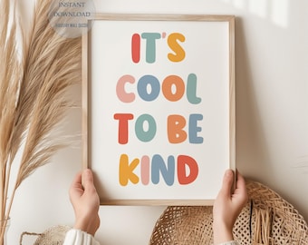 May include: A framed print with the text "It's cool to be kind" in colorful, rounded letters. The letters are in shades of pink, blue, yellow, and orange.