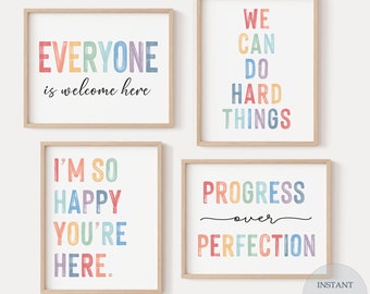 May include: Four printable wall art prints with rainbow colored text. The prints feature the following phrases: "Everyone is welcome here", "We can do hard things", "I'm so happy you're here", and "Progress over perfection".