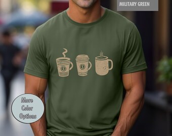 May include: A green t-shirt with a graphic of three coffee cups. The cups are brown and have a white outline. The text "MILITARY GREEN" is in the top right corner of the image.
