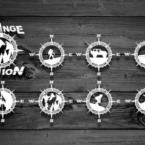 May include: Eight white compass designs with different activities, including hiking, driving, kayaking, and snowboarding. The text "STRANGE MOTION" is at the top of the image.