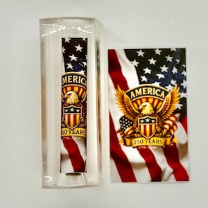 May include: A patriotic design featuring the American flag, stars, and an eagle. The design is on a clear rectangular case and a rectangular card. The text reads "AMERICA 250 YEARS 1776-2026".