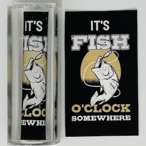 May include: A black and white sticker with a fish jumping out of the water. The text on the sticker reads "It's Fish O'Clock Somewhere".