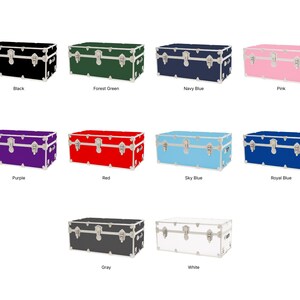 May include: A collection of rectangular storage trunks in various colors, including black, forest green, navy blue, pink, purple, red, sky blue, royal blue, gray, and white. Each trunk has silver-colored hardware and the color name is printed below.