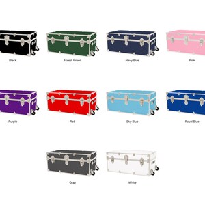 May include: A collection of rectangular storage trunks in various colors, including black, forest green, navy blue, pink, purple, red, sky blue, royal blue, gray, and white. Each trunk has silver-colored hardware and wheels.