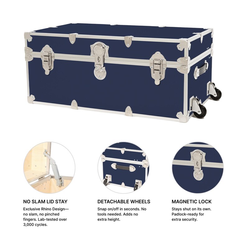 May include: A navy blue trunk with silver hardware and white trim. Features include a magnetic lock, detachable wheels, and a no-slam lid stay. The trunk is designed for secure storage and easy transport.