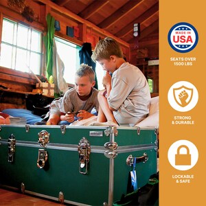 May include: A dark green trunk with silver hardware and a lock. The trunk is in a room with two children sitting on top of it. The trunk is labeled "Made in USA", "Seats over 1500 lbs", "Strong & Durable", and "Lockable & Safe".