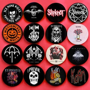 May include: A collection of sixteen circular pin-back buttons featuring various band logos and graphic illustrations, including Ice Nine Kills, Slipknot, Motionless In White, Sleep Token, I Prevail, Korn, Bad Omens, and Avenged Sevenfold.