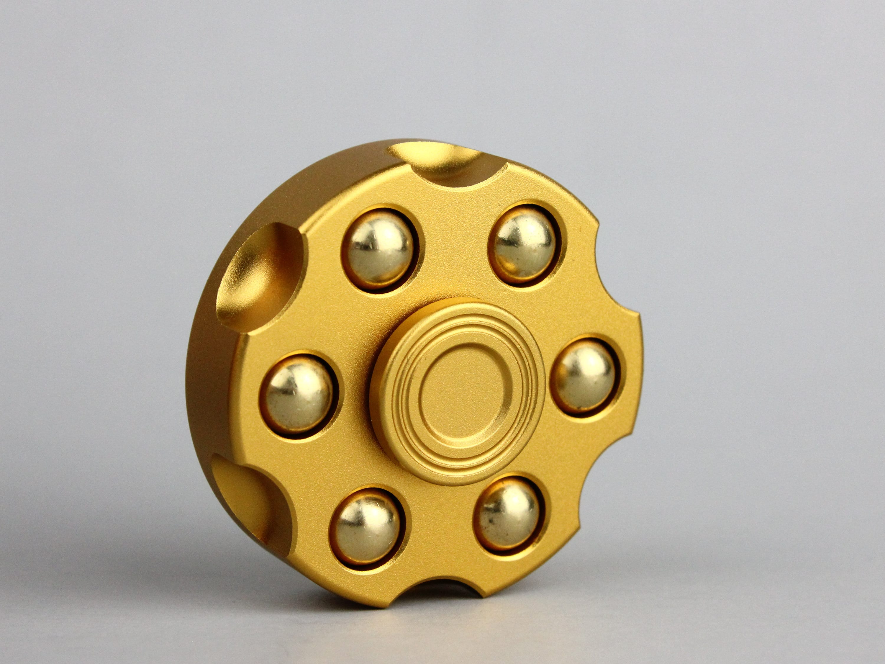 Revolver fidget spinner métal en laiton avec finition colorée plaquée.  Poids amovibles -  France