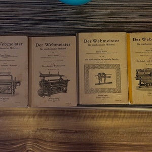 May include: Four vintage books titled "Der Webmeister" for mechanical weaving. Each book features a different illustration of a weaving loom.