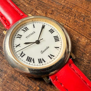 Tutima Ladies Quartz Watch Gold Tone Round Designer Roman Numerals Elegant Woman Timepiece