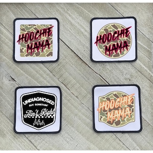 May include: Four square patches with black borders. Three patches feature the text "HOOCHIE MAMA" in pink or orange script over a camouflage pattern. The fourth patch reads "UNDIAGNOSED BUT SOMETHIN' AIN'T RIGHT" in a black and white design.