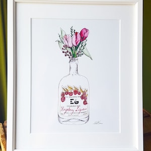 May include: A white framed print of a hand-drawn illustration of a bottle of raspberry liqueur with a bouquet of pink tulips in the bottle's neck. The bottle label reads "The Spencerfield Spirit Co. EG Edinburgh Gin Raspberry Liqueur Infused with Fresh Raspberries 70% vol."