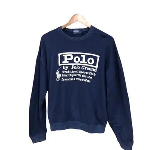 May include: A navy blue sweatshirt with a white logo that reads "Polo by Polo Ground Traditional Sports Club Healthycircle for the Friendsin Toast Wear".