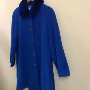 May include: A royal blue coat with a faux fur collar. The coat has a button closure and long sleeves.