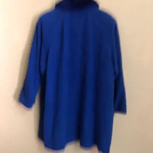 May include: A royal blue, long-sleeved jacket with a high collar.