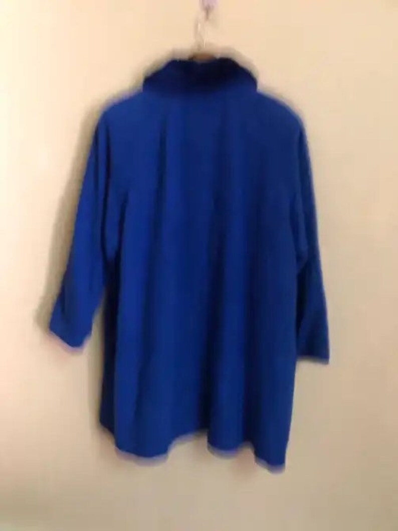 May include: A royal blue, long-sleeved jacket with a high collar.