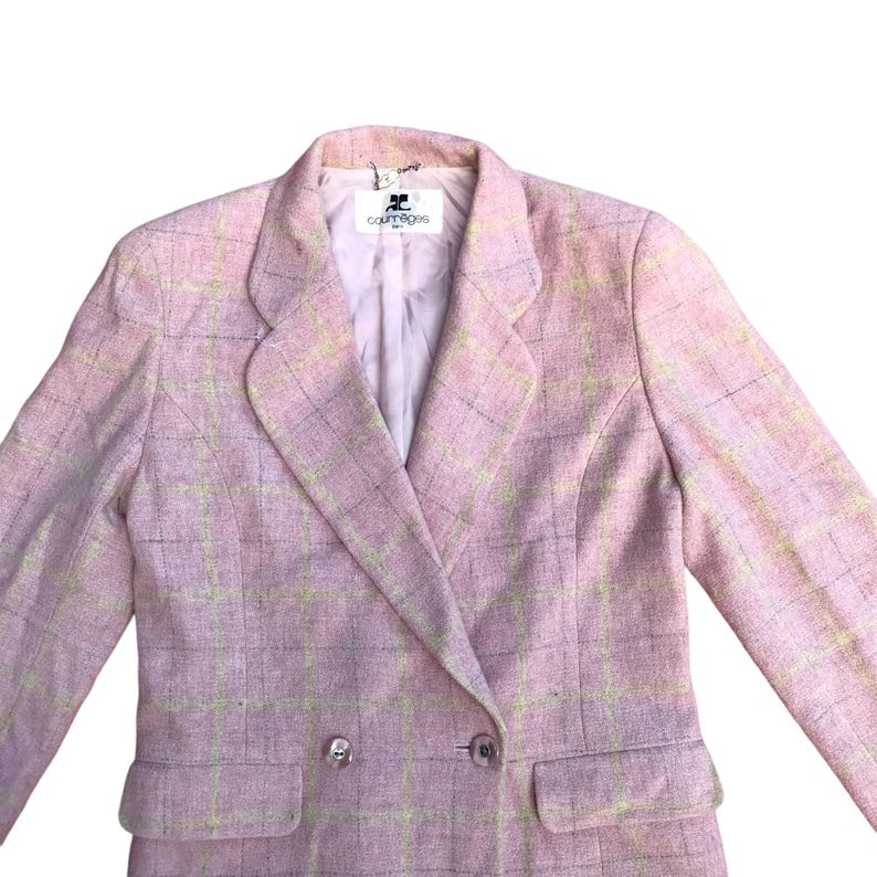 May include: A pink and yellow plaid blazer with a double breasted closure and a label that reads "Courreges" in black text.